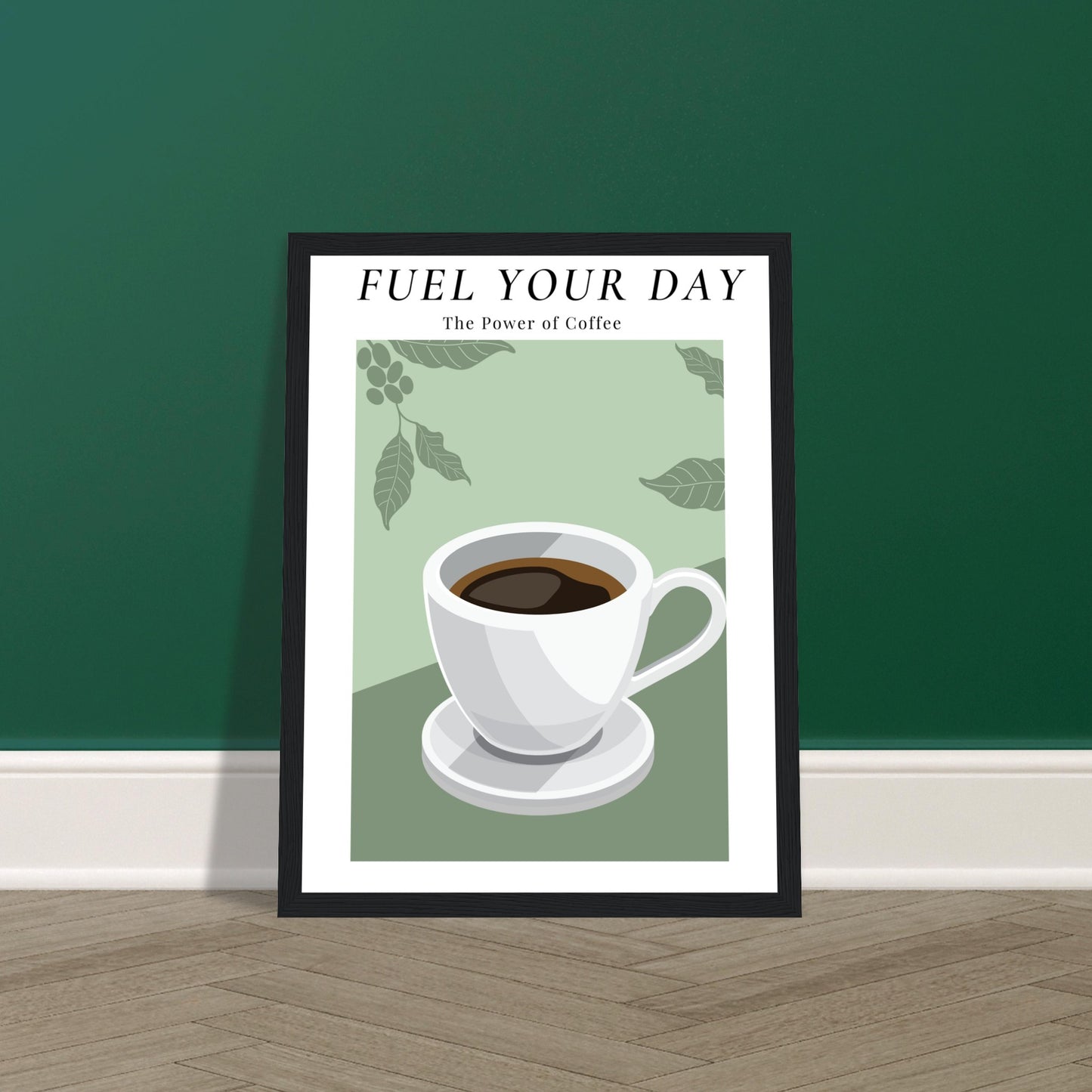 Ein Bild im Schwarzen Rahmen mit einer Tasse Kaffee auf einem Grünfarbigen Hintergrund mit Arabica Blätter als Akzente. Oben mittig des Bildes steht: "FUEL YOUR DAY" mit der Unterschrift "The Power of Coffee" dass auf dem Boden steht und an der Wand Lehnt.