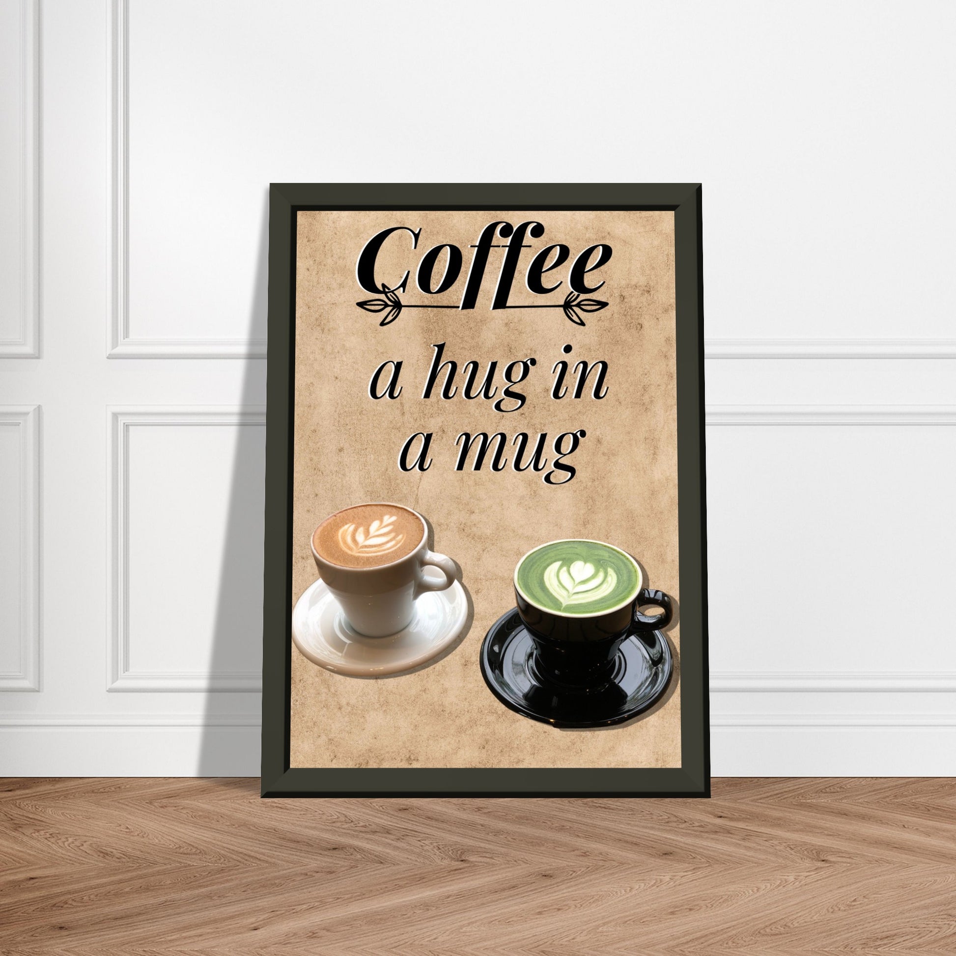 Eingerahmtes Bild mit der Überschrift: "Coffee" und dem Titel: "a hug in a mug" mit zwei Tassen Kaffee auf einem Beigen Hintergrund an einer weißen Wand lehnend