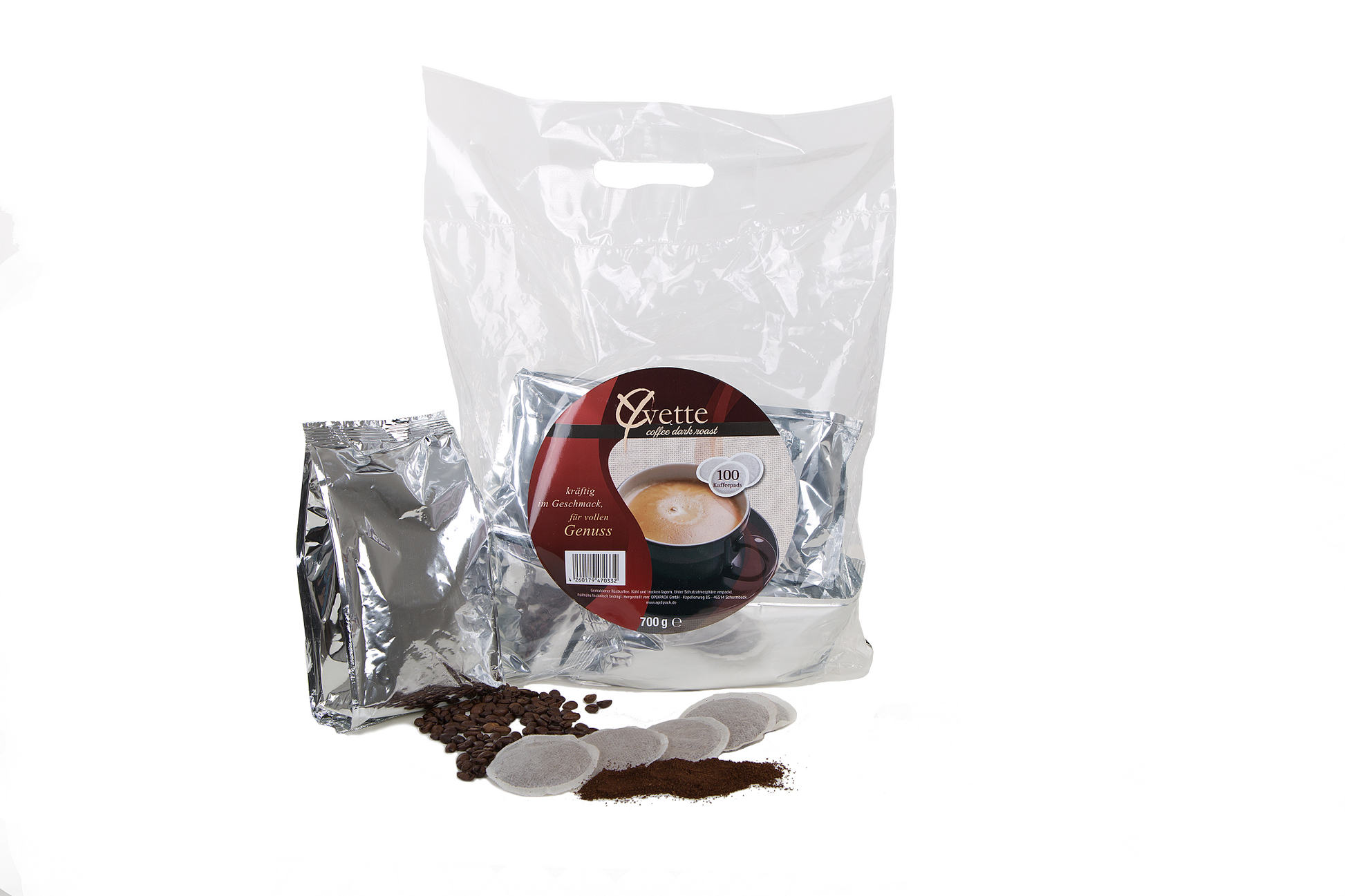 Yvette Kaffeepads Vorratspack mit silberne Verpackung und verstreuten Kaffeepads, Kaffeebohne und Mahlkaffee