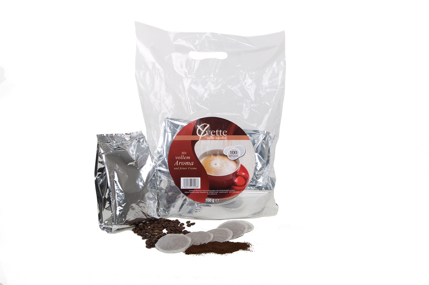 Yvette Kaffeepads Vorratspack mit silberne Verpackung und verstreuten Kaffeepads, Kaffeebohne und Mahlkaffee