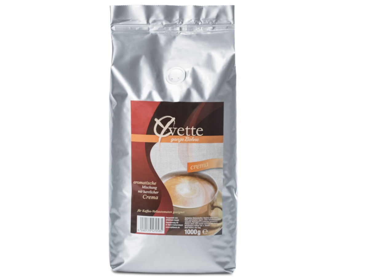 Ein silberner Beutel mit 1000g frisch gerösteten Crema-Kaffeebohnen der Marke Yvette Kaffee. Der Beutel zeigt das Logo der Marke und die Produktbezeichnung. Auf dem Etikett ist eine Tasse Kaffee, die ein Gefühl von Frische und Qualität vermitteln.
